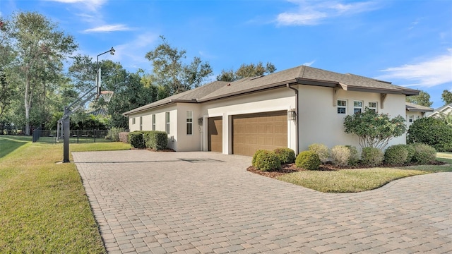 view of side of property featuring a garage and a lawn