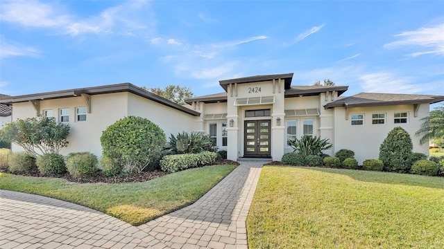 prairie-style home with a front yard and french doors