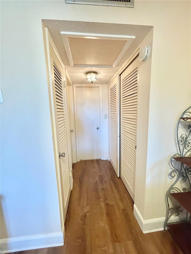 corridor featuring dark hardwood / wood-style floors