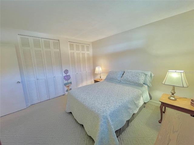 carpeted bedroom with multiple closets