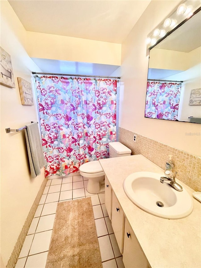 bathroom featuring toilet, vanity, tile patterned flooring, and walk in shower