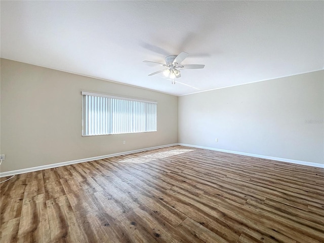 unfurnished room with ceiling fan and hardwood / wood-style flooring