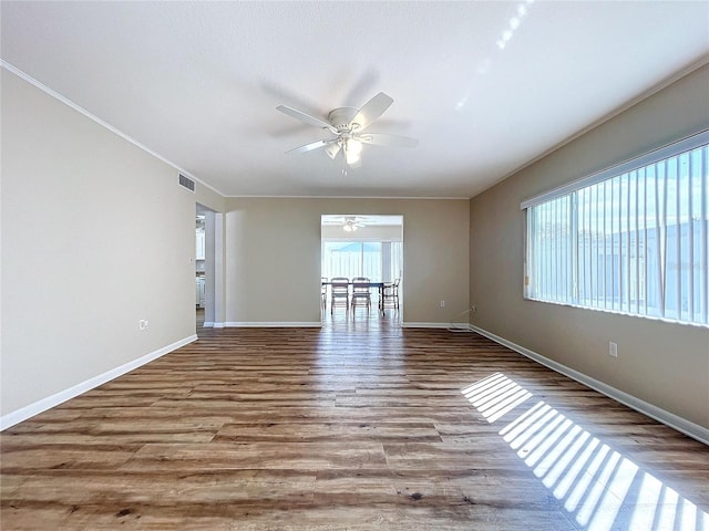 unfurnished room featuring ceiling fan, a wealth of natural light, and light hardwood / wood-style floors