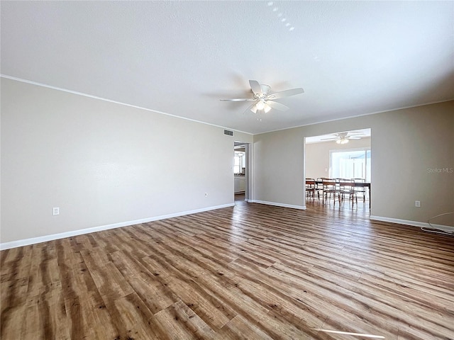 unfurnished room with light wood-type flooring and ceiling fan