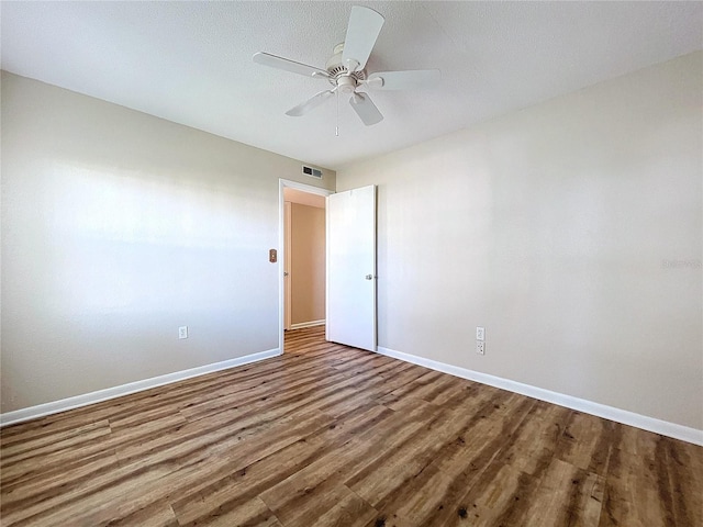 spare room with hardwood / wood-style flooring and ceiling fan