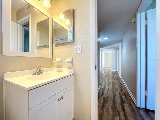 bathroom featuring vanity and hardwood / wood-style floors