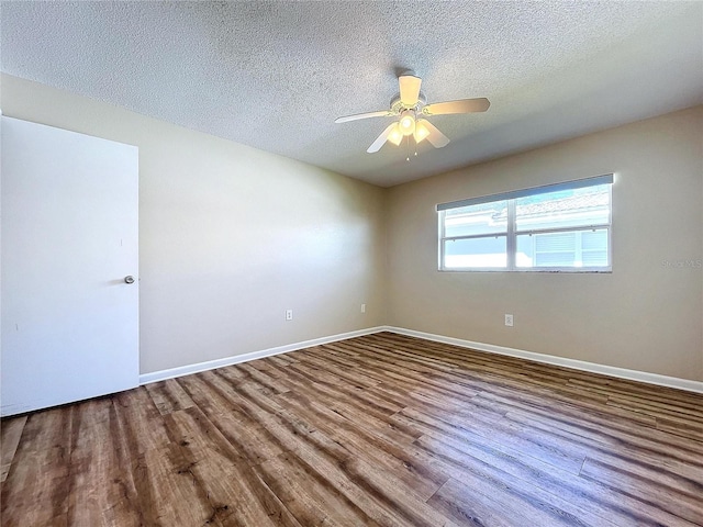 spare room with a textured ceiling, ceiling fan, and hardwood / wood-style flooring