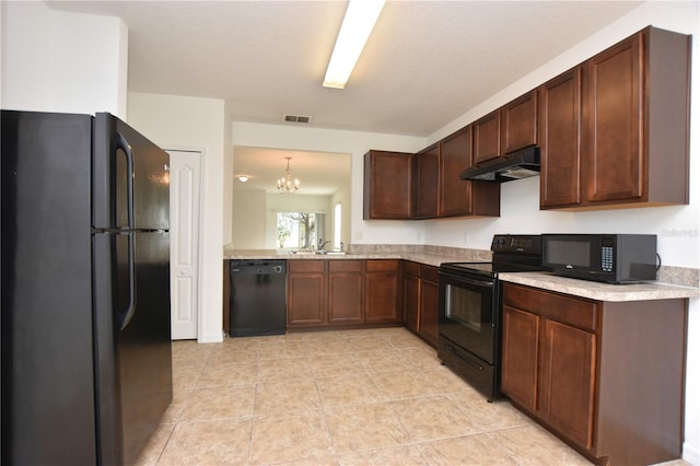 kitchen featuring black appliances, decorative light fixtures, sink, and a chandelier