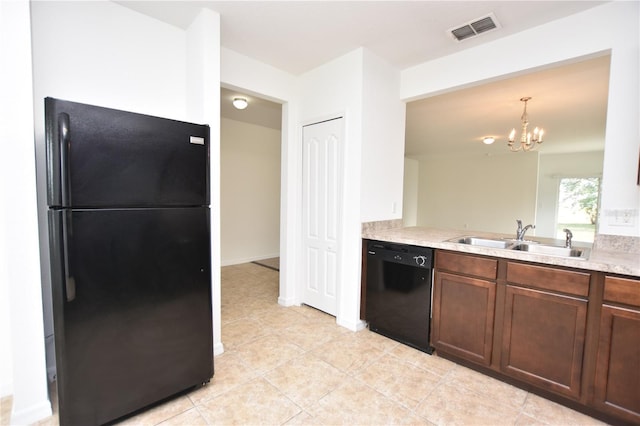 kitchen featuring an inviting chandelier, light tile patterned flooring, hanging light fixtures, black appliances, and sink