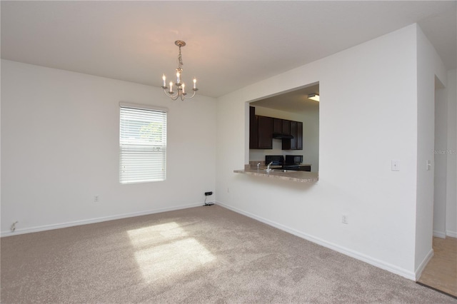 unfurnished room with light colored carpet and a chandelier