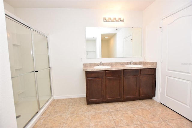 bathroom with a shower with door and vanity