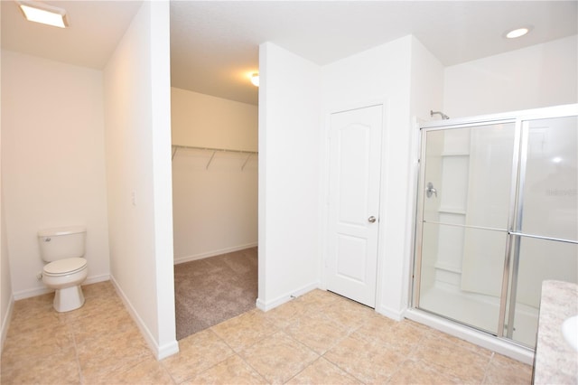 bathroom featuring toilet and walk in shower