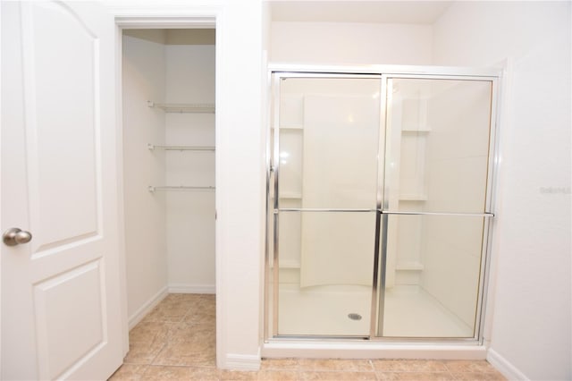 bathroom featuring tile patterned flooring and a shower with door