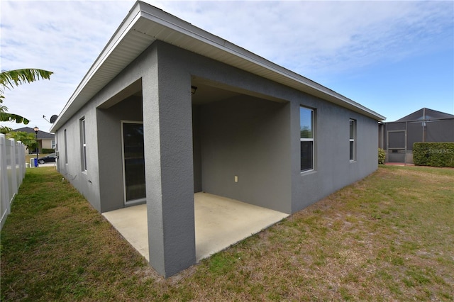 back of house featuring a patio area and a yard