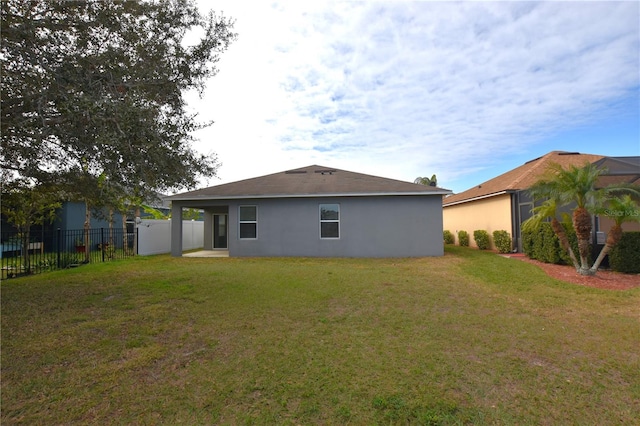 back of house with a yard