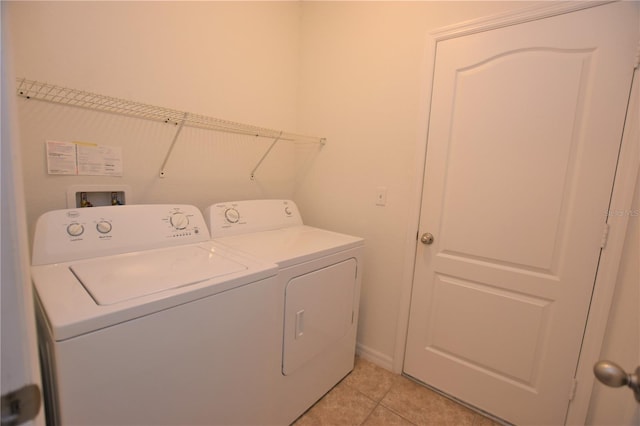 laundry area featuring light tile patterned flooring and separate washer and dryer