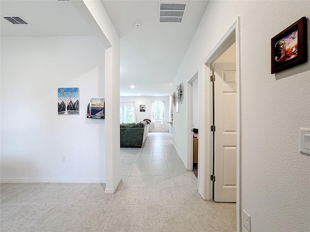 corridor with light tile patterned floors