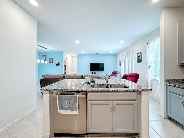 kitchen with gray cabinets, sink, dishwasher, and a center island with sink