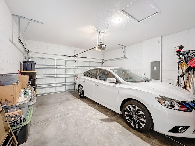 garage featuring electric panel and a garage door opener