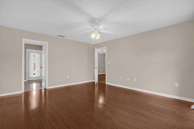 empty room featuring ceiling fan and dark hardwood / wood-style floors