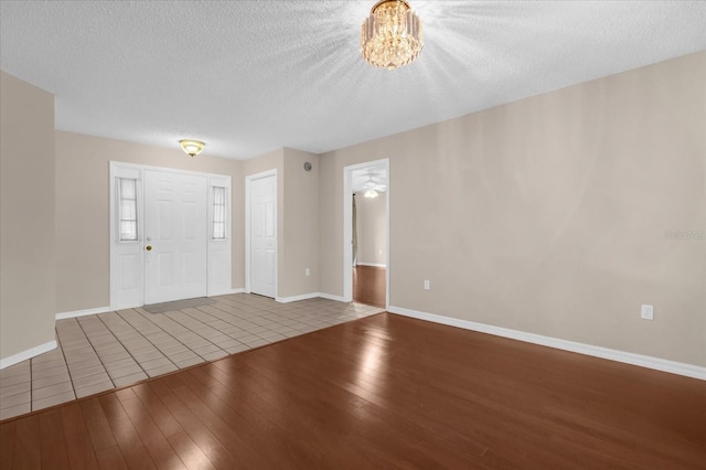 entryway featuring ceiling fan, a textured ceiling, and hardwood / wood-style flooring