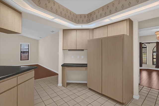 kitchen featuring light tile patterned floors and light brown cabinetry