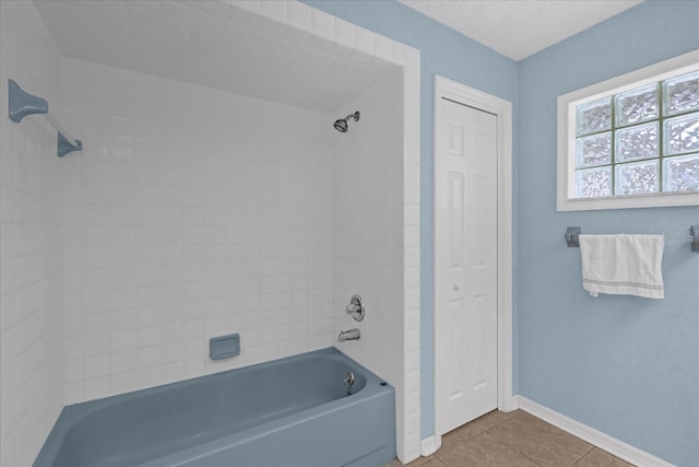 bathroom featuring tile patterned flooring and tiled shower / bath combo