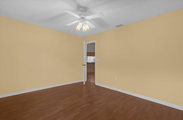 unfurnished room featuring ceiling fan, wood-type flooring, and a textured ceiling