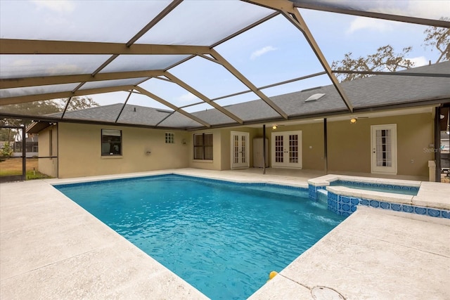 view of pool featuring glass enclosure, a patio area, french doors, and an in ground hot tub