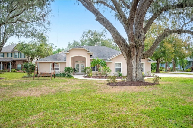 view of front facade featuring a front lawn and french doors