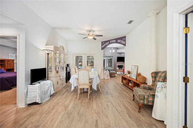 living room with ceiling fan, light hardwood / wood-style floors, and french doors