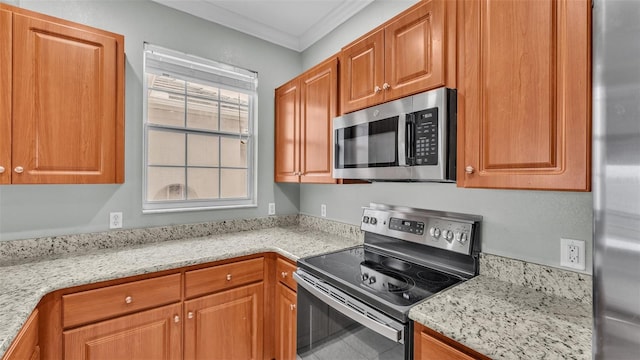 kitchen with crown molding, appliances with stainless steel finishes, and light stone counters