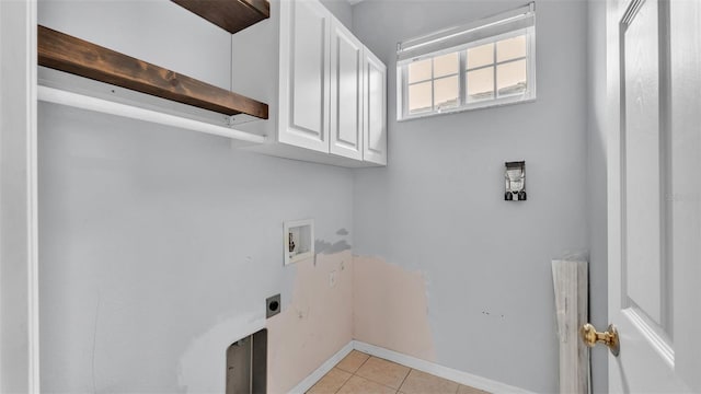 laundry area featuring cabinets, light tile patterned flooring, hookup for a washing machine, and hookup for an electric dryer