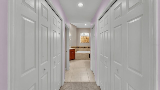 hall with light tile patterned floors