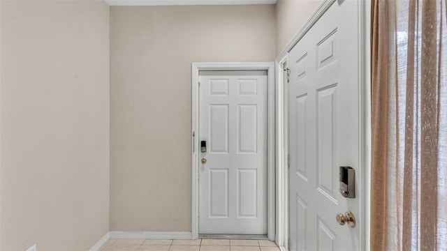 entryway with light tile patterned flooring