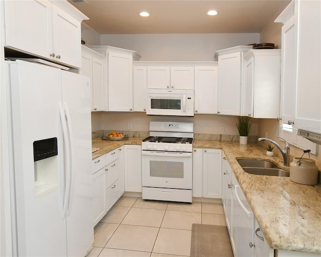 kitchen with sink, white cabinets, and white appliances