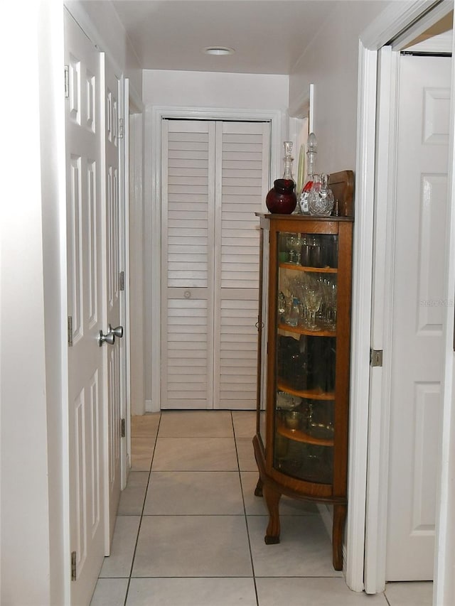 corridor featuring light tile patterned flooring