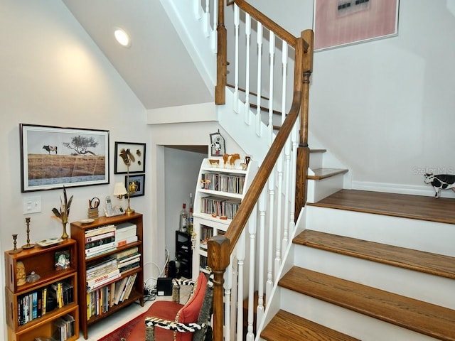 staircase featuring lofted ceiling