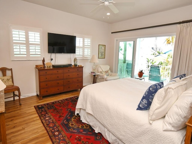 bedroom with ceiling fan, access to exterior, and hardwood / wood-style flooring