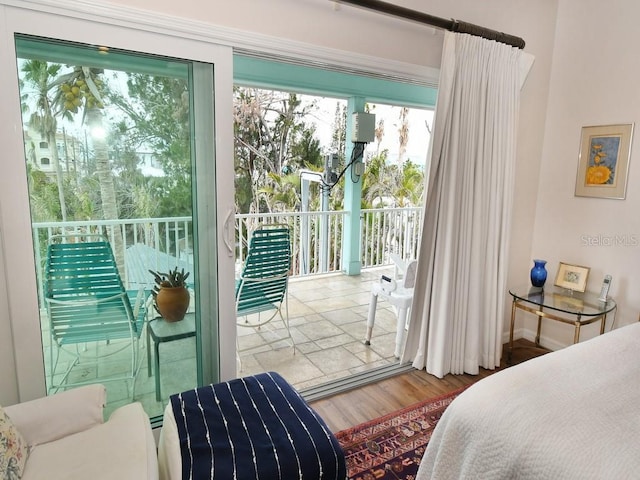 bedroom featuring hardwood / wood-style floors and access to outside