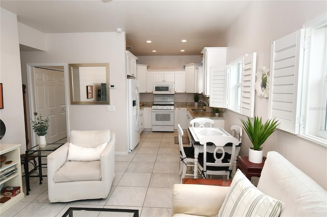 tiled living room with sink and plenty of natural light