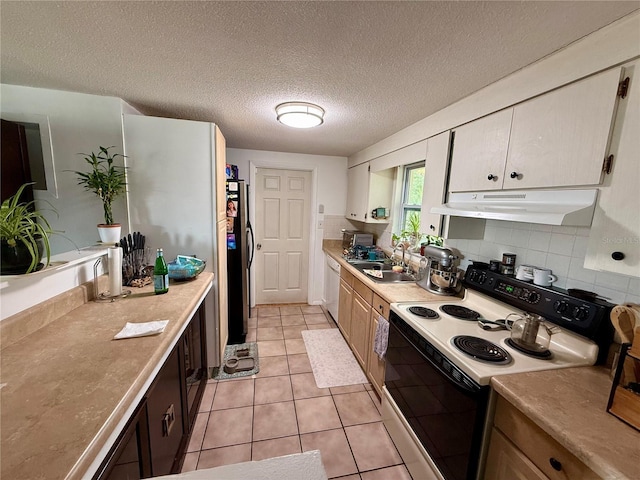 kitchen with light tile patterned floors, tasteful backsplash, electric stove, a textured ceiling, and sink