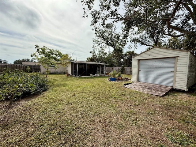 view of yard with an outdoor structure and a sunroom