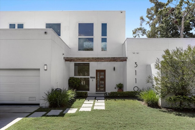 contemporary house with a garage and a front yard