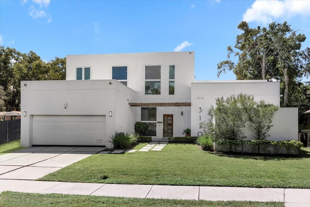 contemporary home with a front yard and a garage