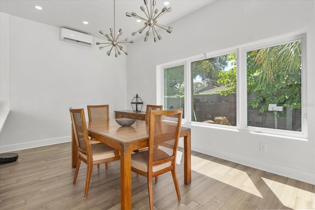 dining room featuring a chandelier, wood-type flooring, and an AC wall unit