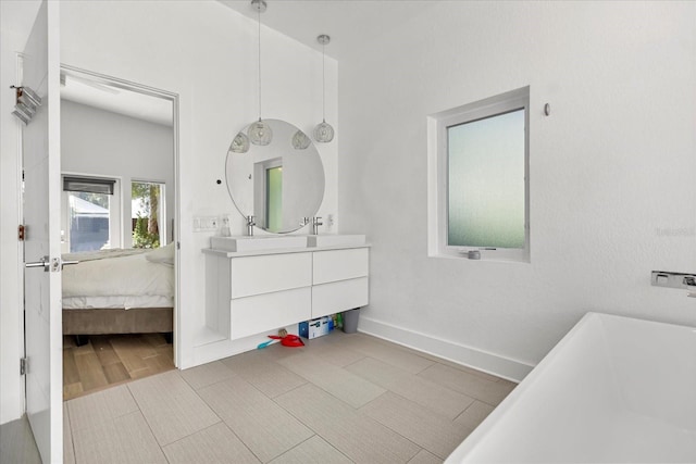 bathroom with vanity and a tub