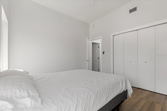 bedroom featuring a closet and dark hardwood / wood-style flooring