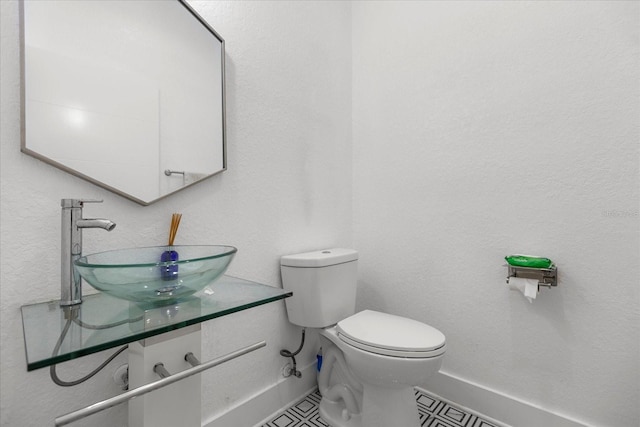 bathroom featuring tile patterned floors, toilet, and vanity