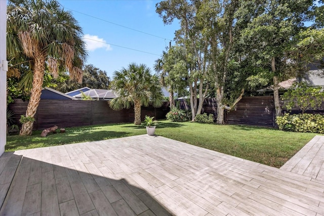 wooden terrace with a patio area and a yard